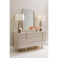 Decorative setup with modern dresser, lamps, mirror.