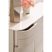 Close-up of open drawer on modern painted dresser.