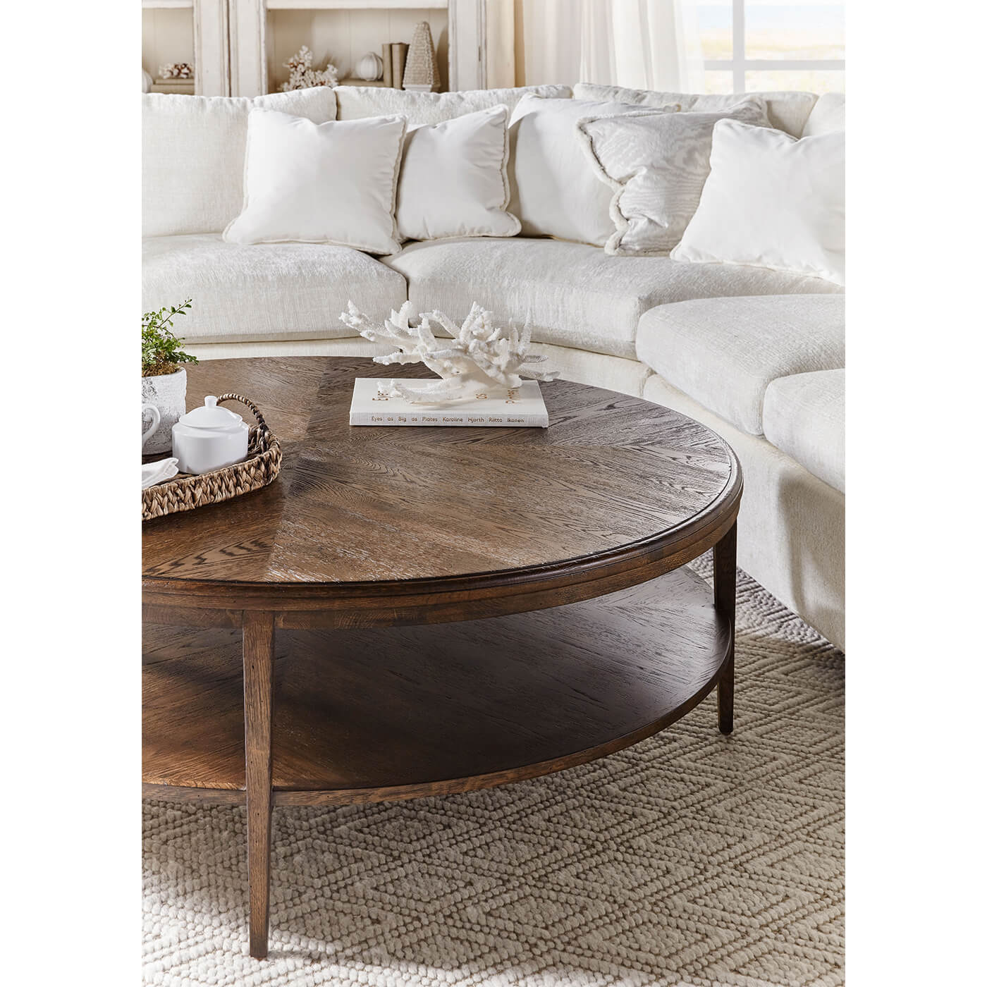 Round coffee table styled with decor in living room.