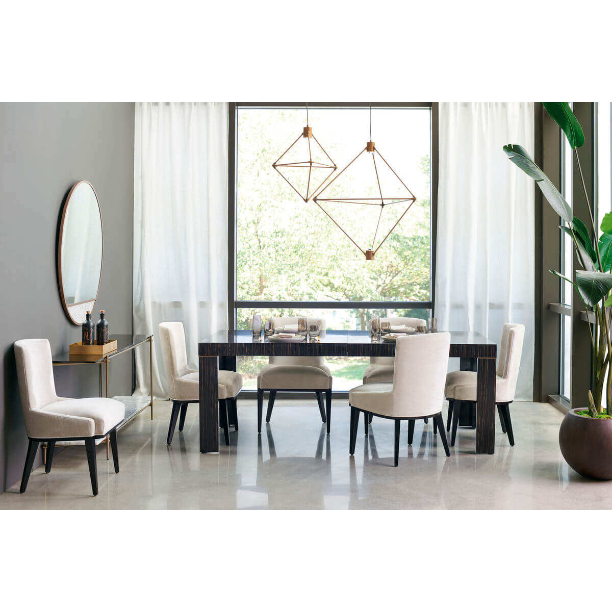 Dining table with chairs near large window.