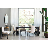 Dining table with chairs near large window.