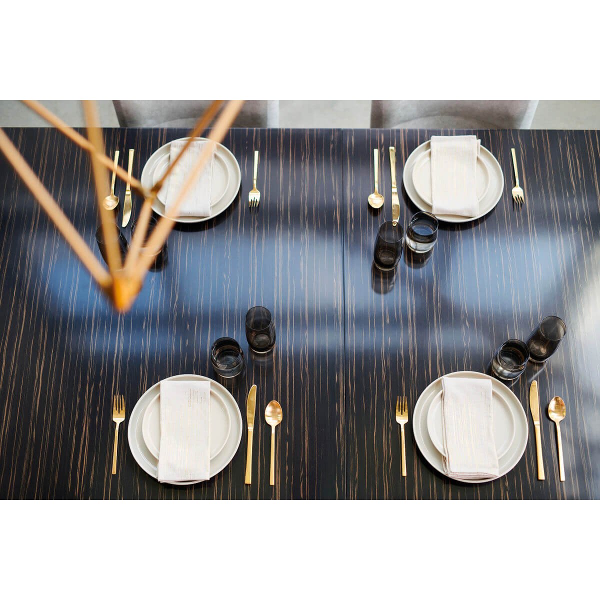 Table set with plates, cutlery, overhead view.