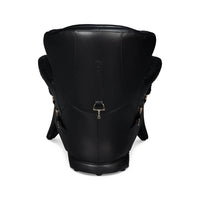 Angled side view of black leather armchair.