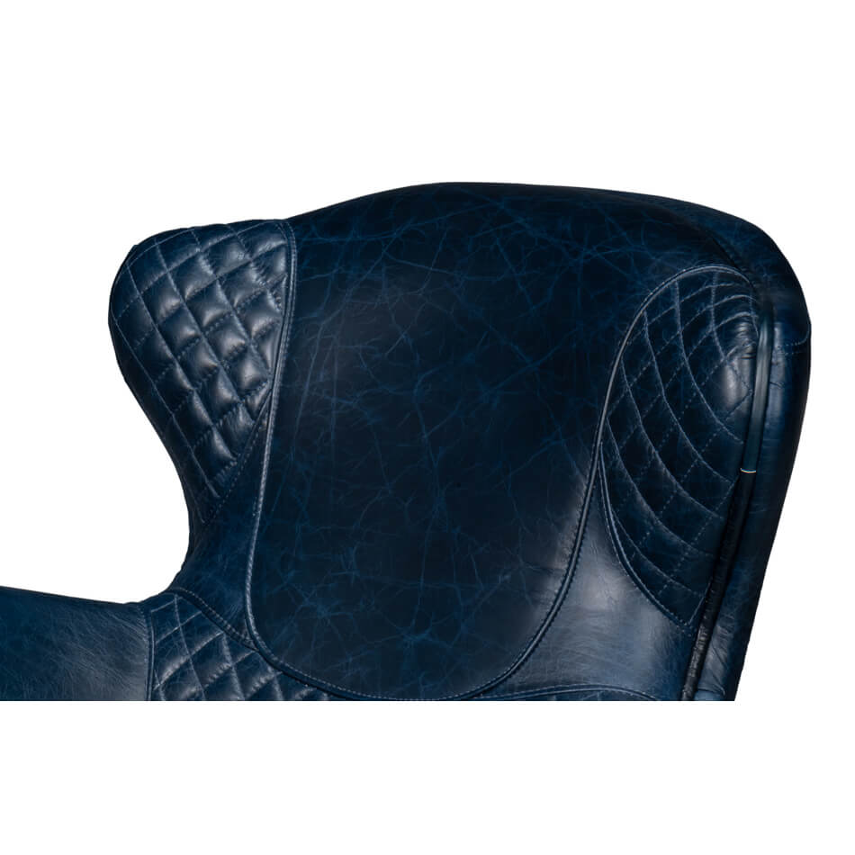 Quilted top of blue leather armchair.