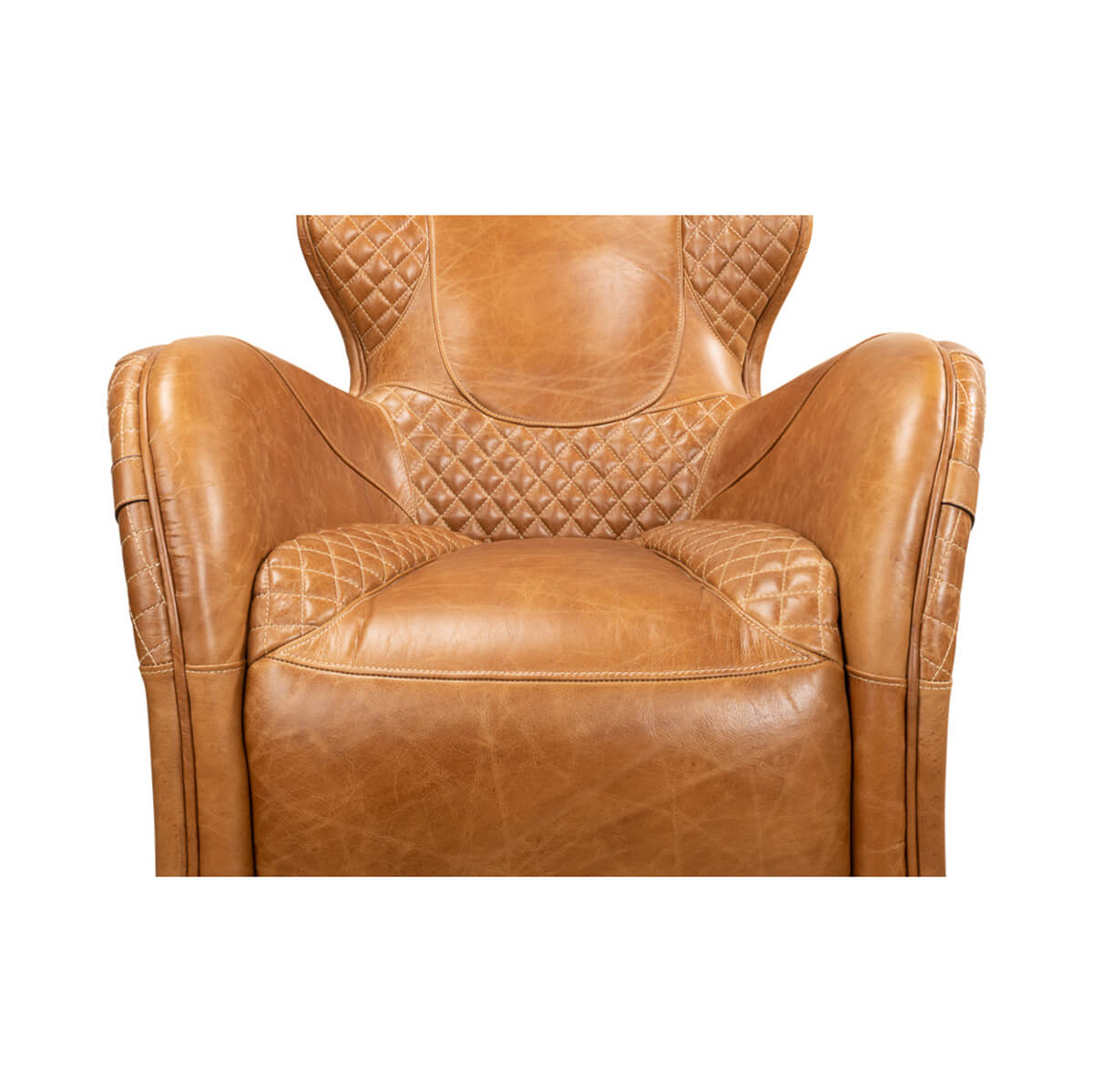Brown quilted leather armchair, close-up of seat and arms.