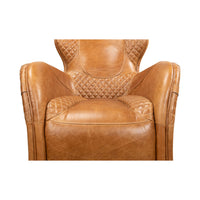 Brown quilted leather armchair, close-up of seat and arms.