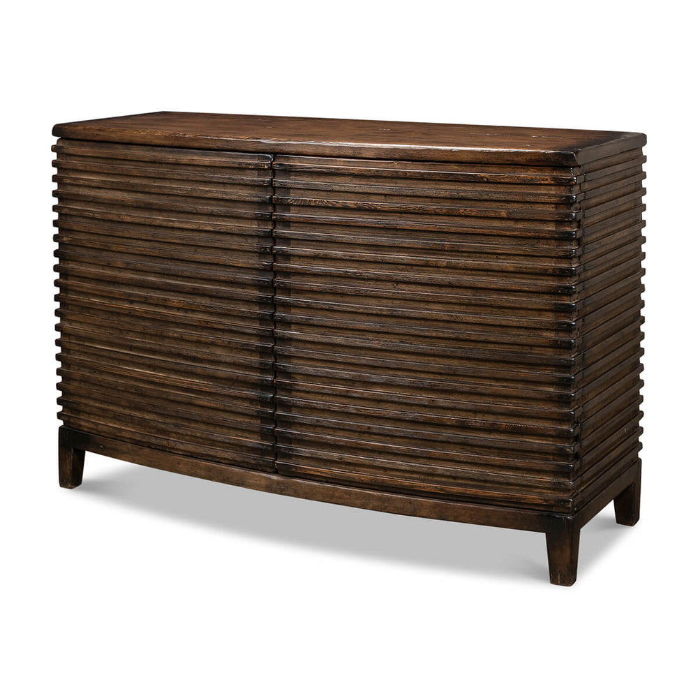 Angled view of ribbed bowfront cabinet, wooden finish.