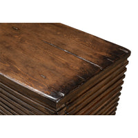 Close-up of ribbed bowfront cabinet top surface detail.