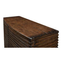 Corner view of ribbed bowfront cabinet with wood grain.