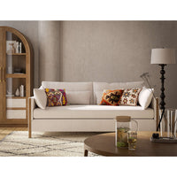 Cozy sofa with colorful pillows, coffee table nearby.