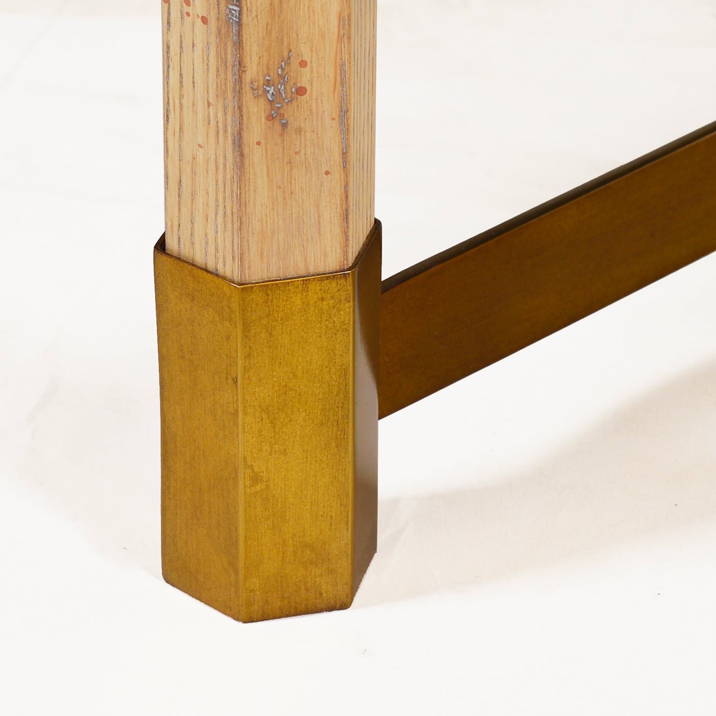 Close-up of coffee table leg with metal accent detail.