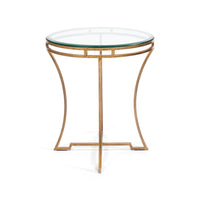 Side view of glass-top round gilded end table.