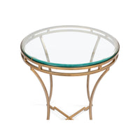 Close-up top view of round gilded end table.