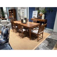 Rustic dining table set with chairs in dining room.