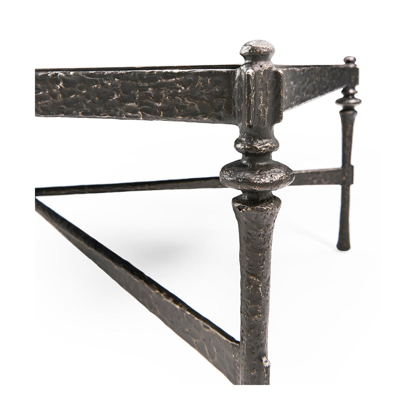 Close-up of leg detailing on rustic hammered iron coffee table.