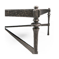 Close-up of leg detailing on rustic hammered iron coffee table.