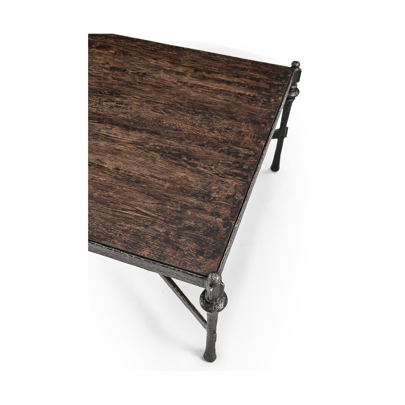 Corner view of tabletop on rustic hammered iron coffee table.