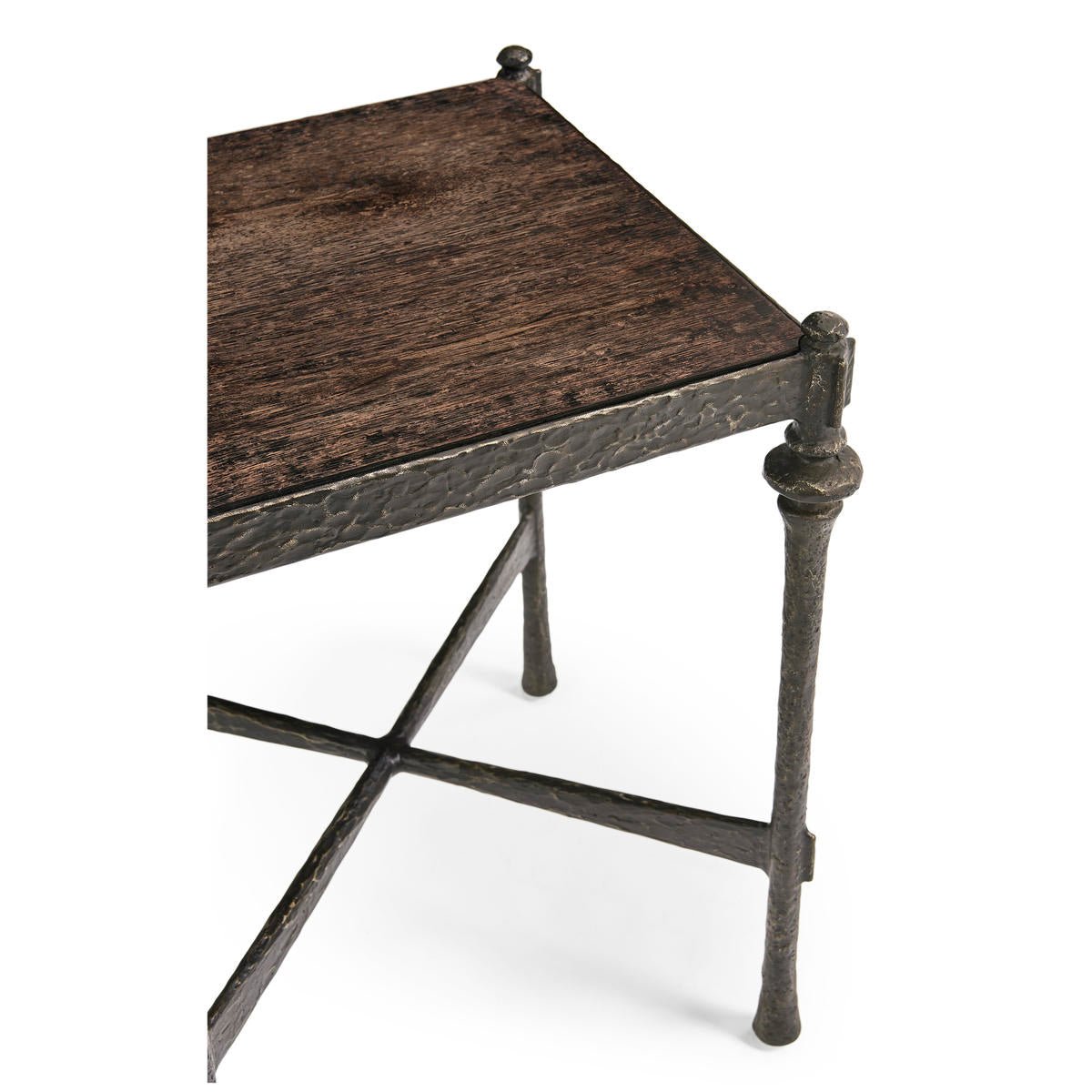 Side view of hammered iron side table, leg crossbeam.