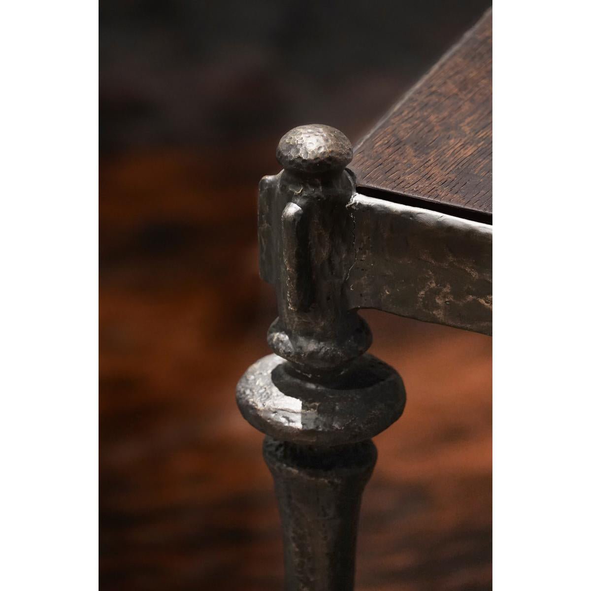 Corner close-up of iron side table, dark finish details.