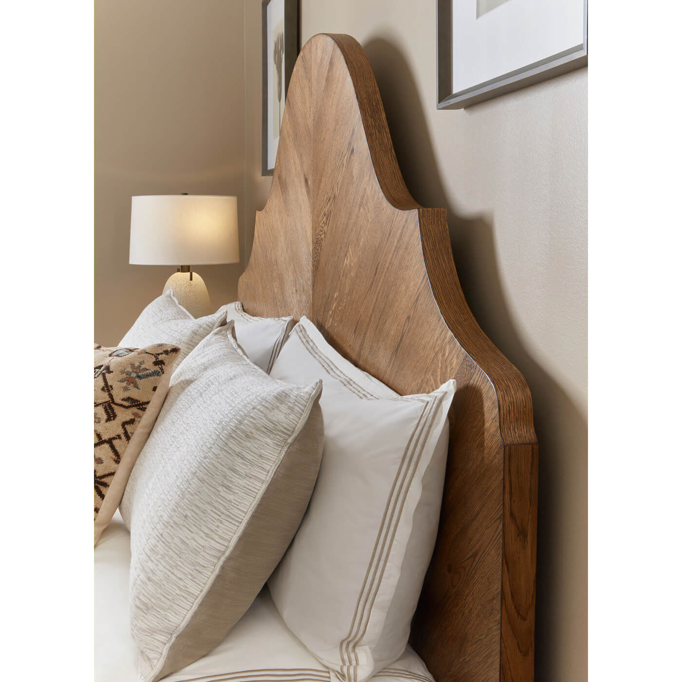 Modern rustic oak king bed headboard with pillows, room setting.