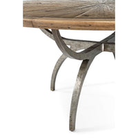 Close-up of metal leg detail on rustic round dining table.