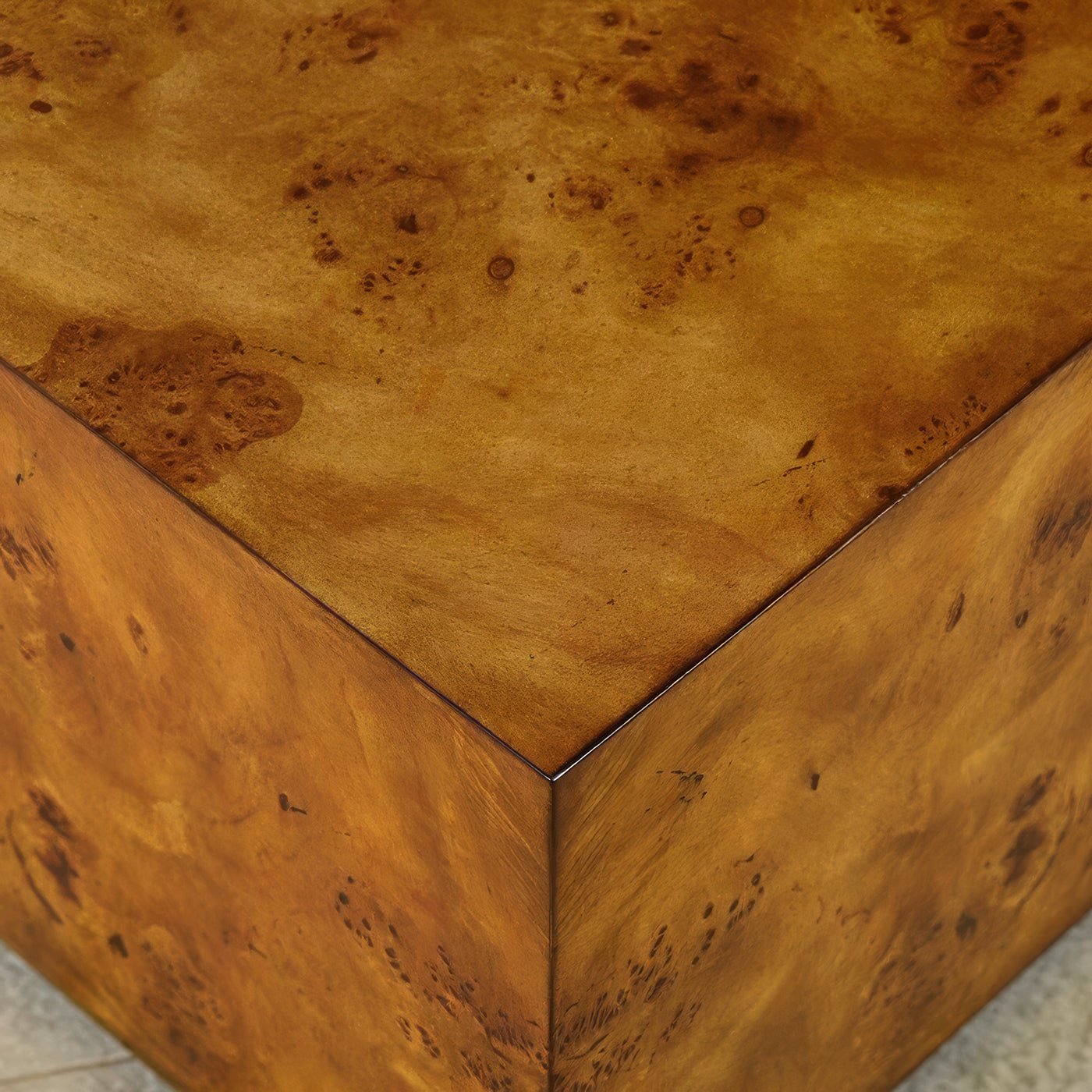 Close-up of square burl wood coffee table corner.