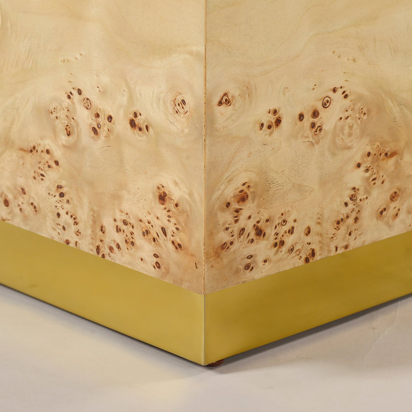 Light burl wood coffee table, corner detail.