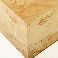 Light burl wood coffee table, top corner perspective.