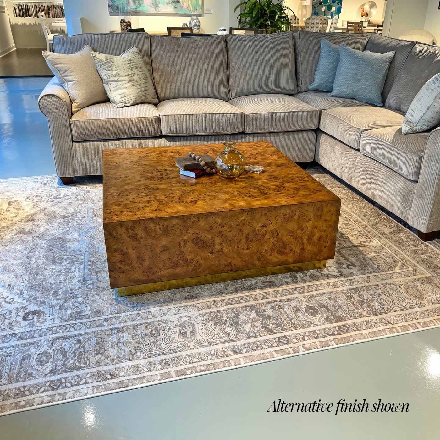 Burl wood coffee table in living room, different finish shown.