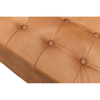 Close-up of tufted pattern on leather bench.