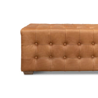 Detailed corner view, modern tufted leather bench.