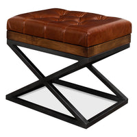 Modern tufted leather stool with X frame, angled view.