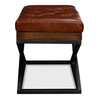 Side view of modern tufted leather stool, X frame design.