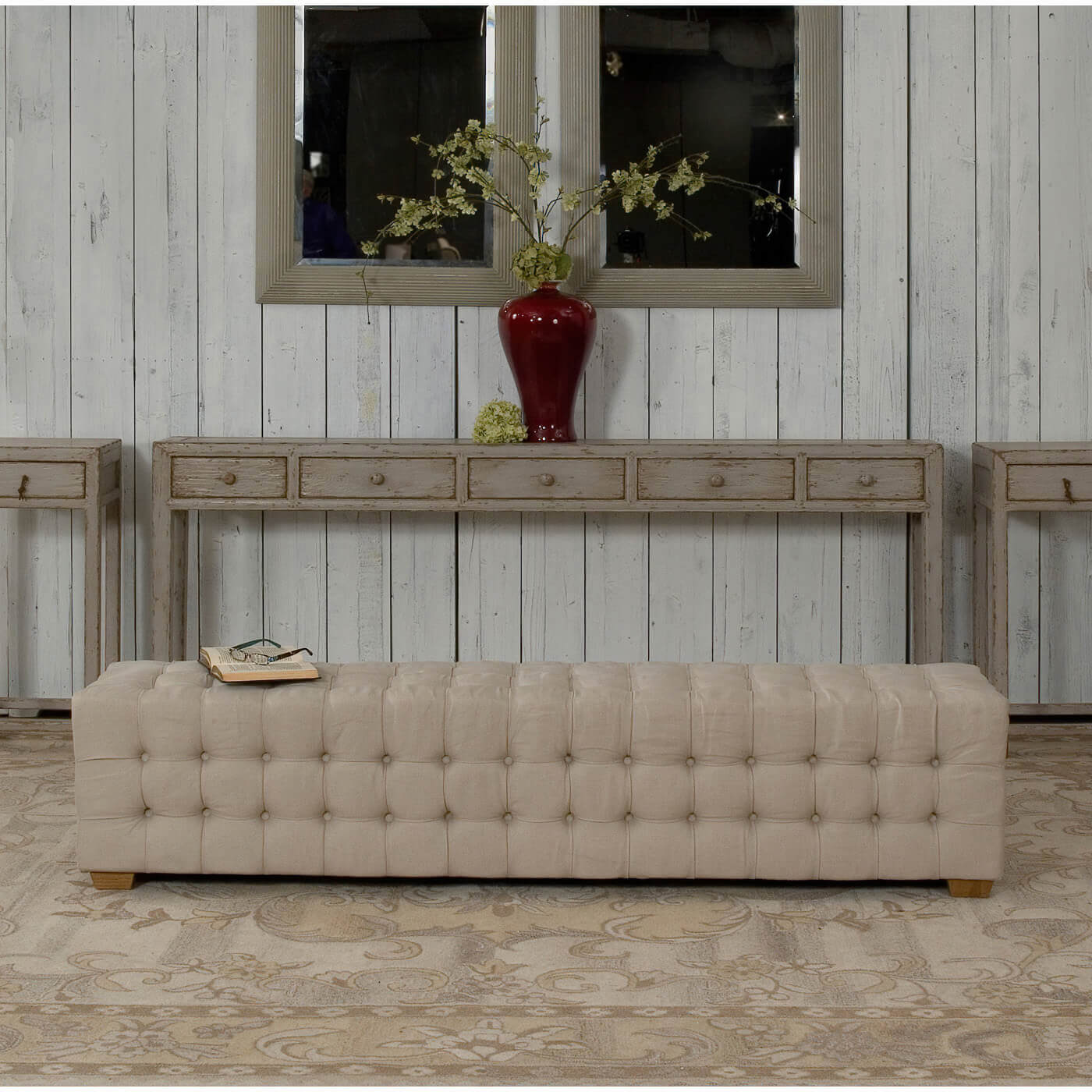 Tufted bench in stylish rustic home setting.