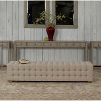 Tufted bench in stylish rustic home setting.