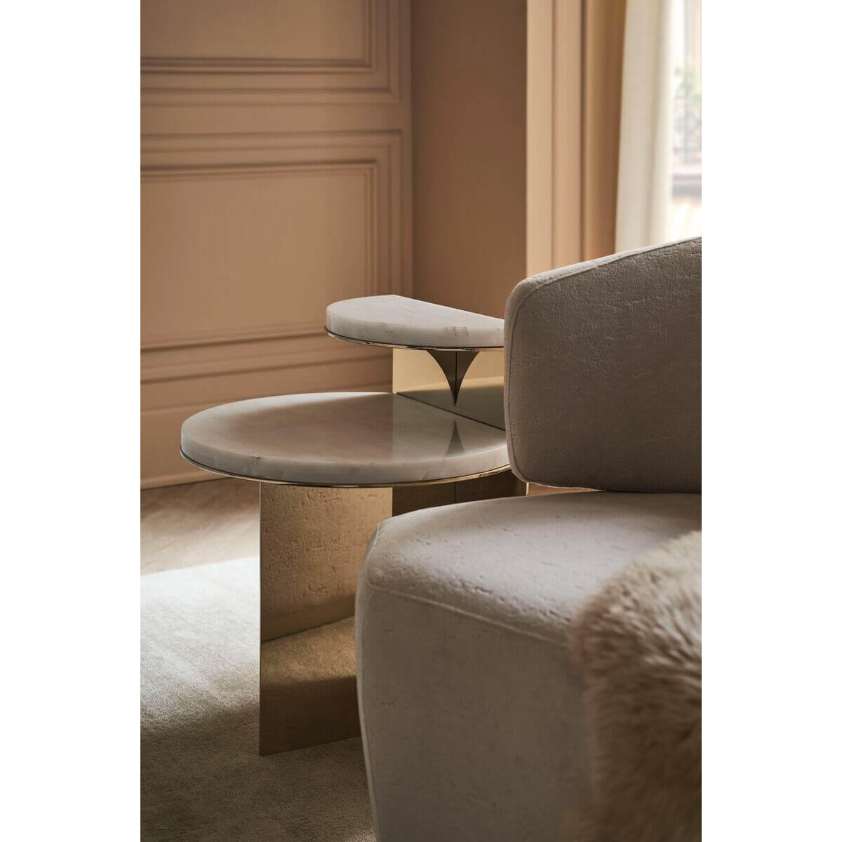 Two-tier end table beside modern couch, stylish setting.