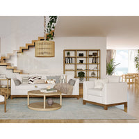 Modern armchair in white, staged in living room setting.