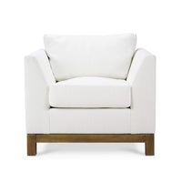 Front view of modern upholstered white armchair.
