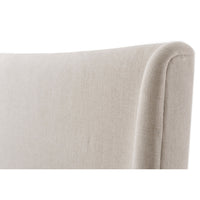 Detail of modern upholstered bed headboard corner.