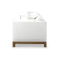 Side view of white modern sofa, pillows displayed.