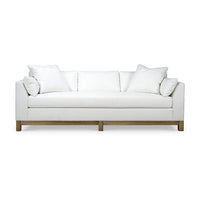White sofa with wooden base, front view.