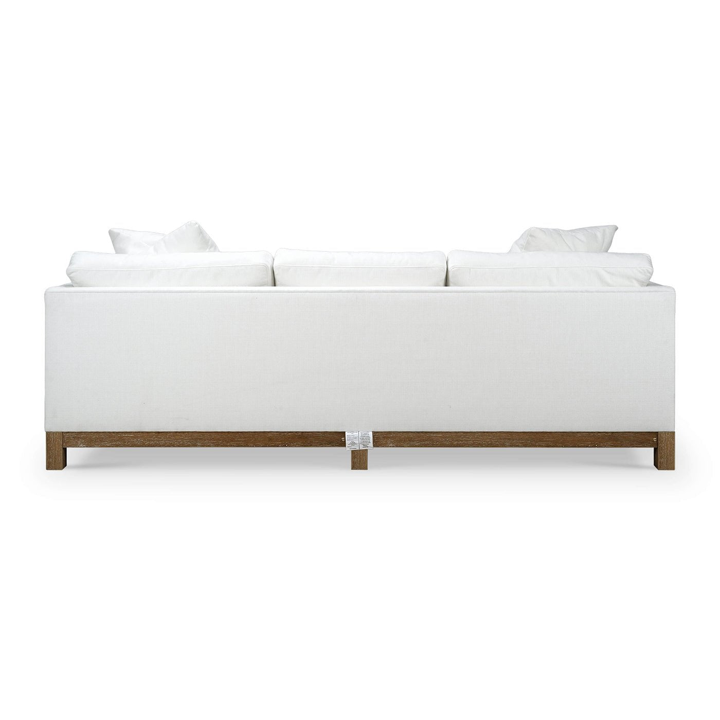 Back view of white modern upholstered sofa.