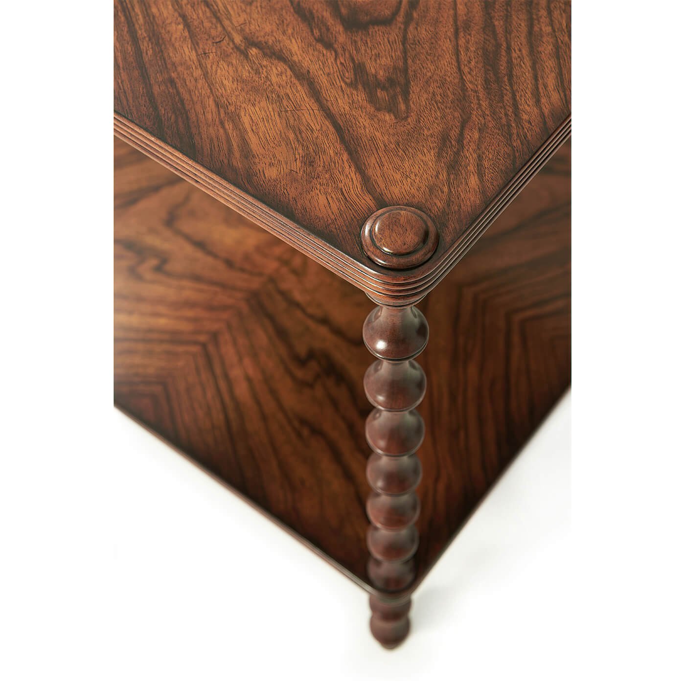 Close-up of walnut table corner and spindle leg detail.