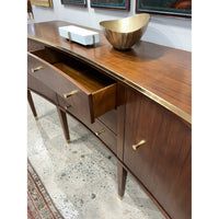 Open drawer of walnut sideboard, showing interior detail.