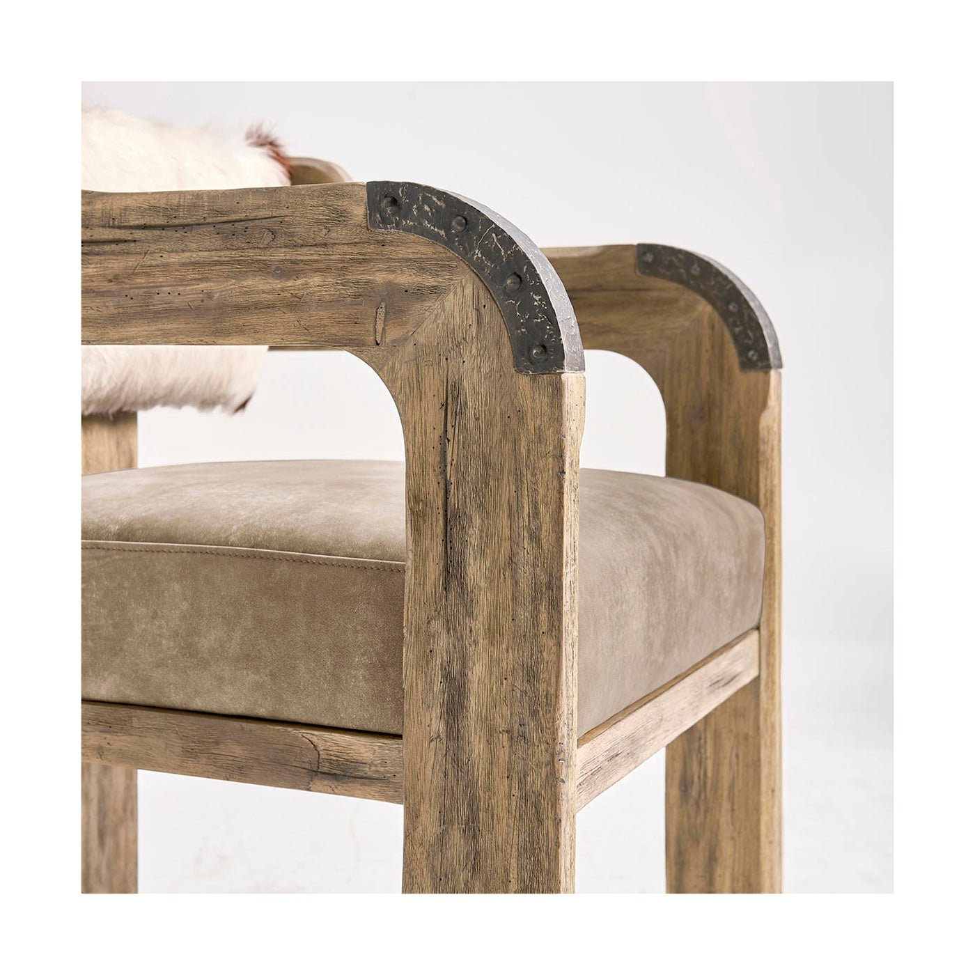 Armrest detail of accent dining chair with metal trim.