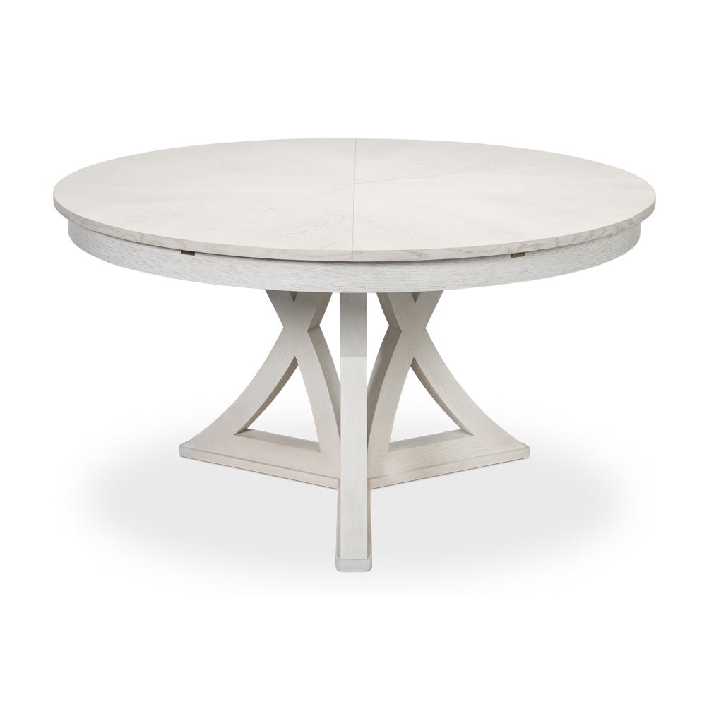 White oak dining table, partially closed with pedestal base.