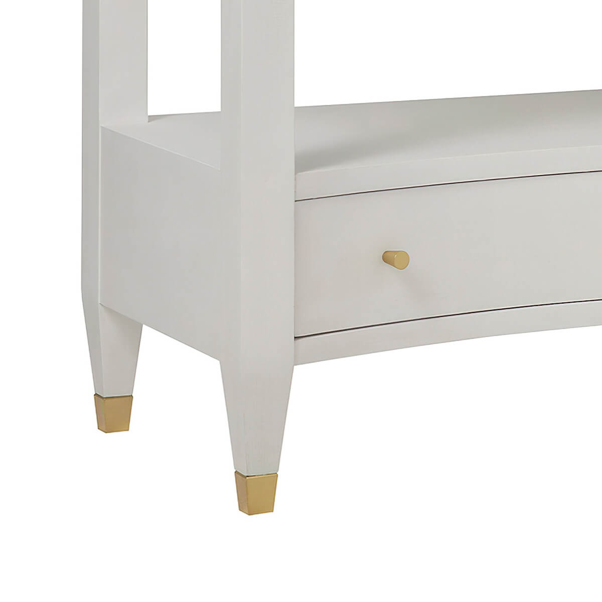Nightstand corner detail with gold leg accents.