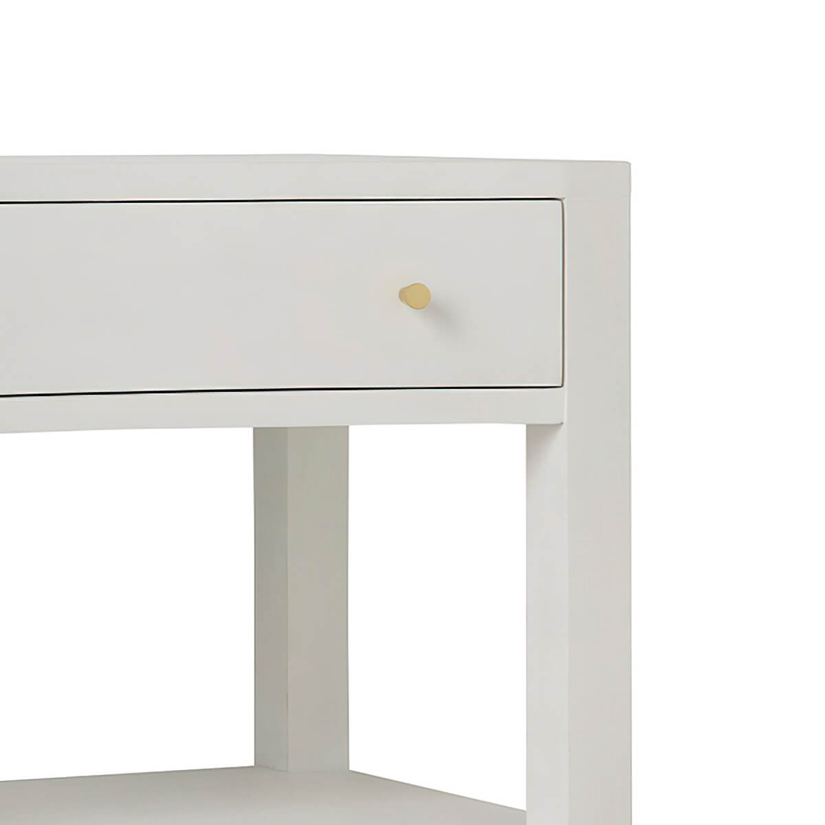 Close-up of nightstand drawer with gold knob.