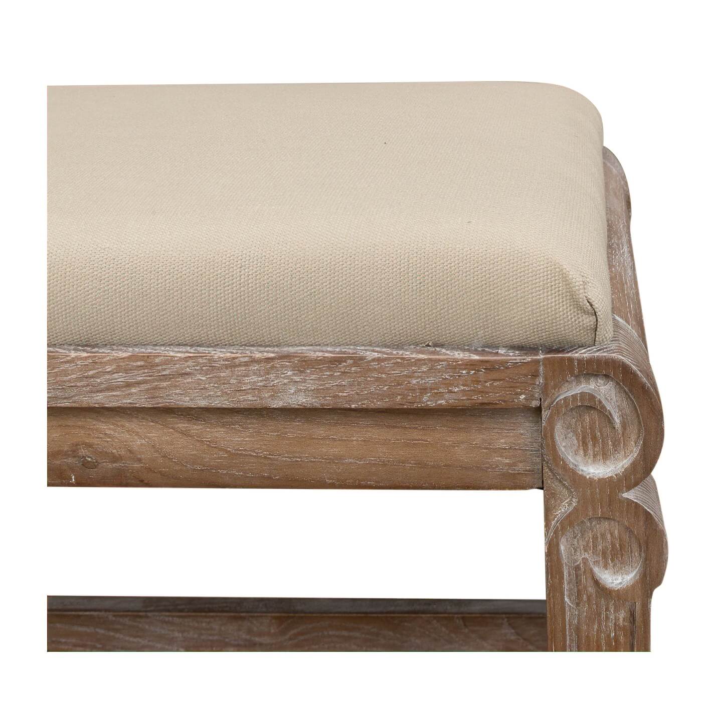 Close-up of bench corner with cushion and carved details.