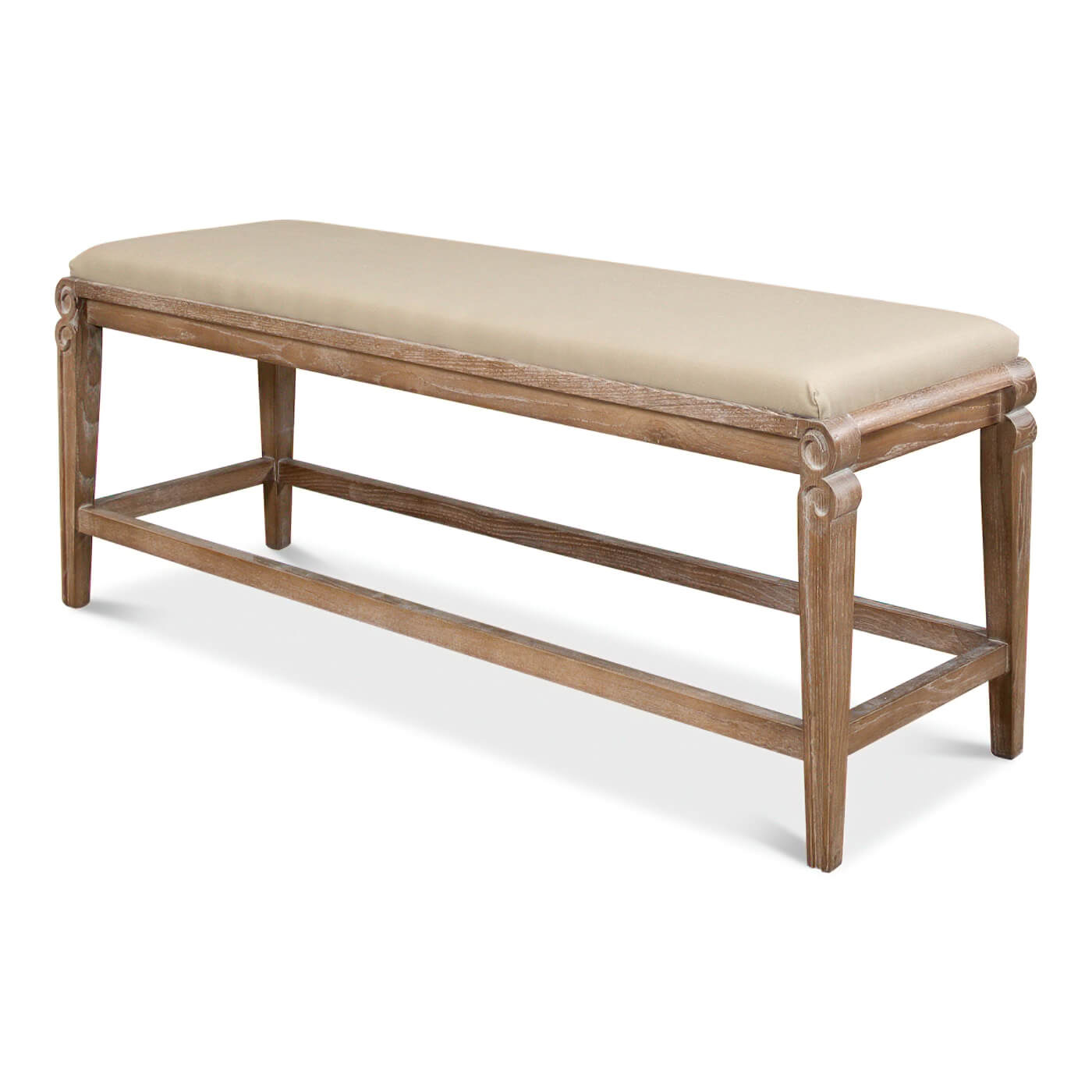 Side view of upholstered bench with whitewash finish.